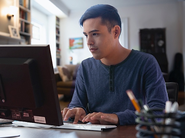 Man typing on computer