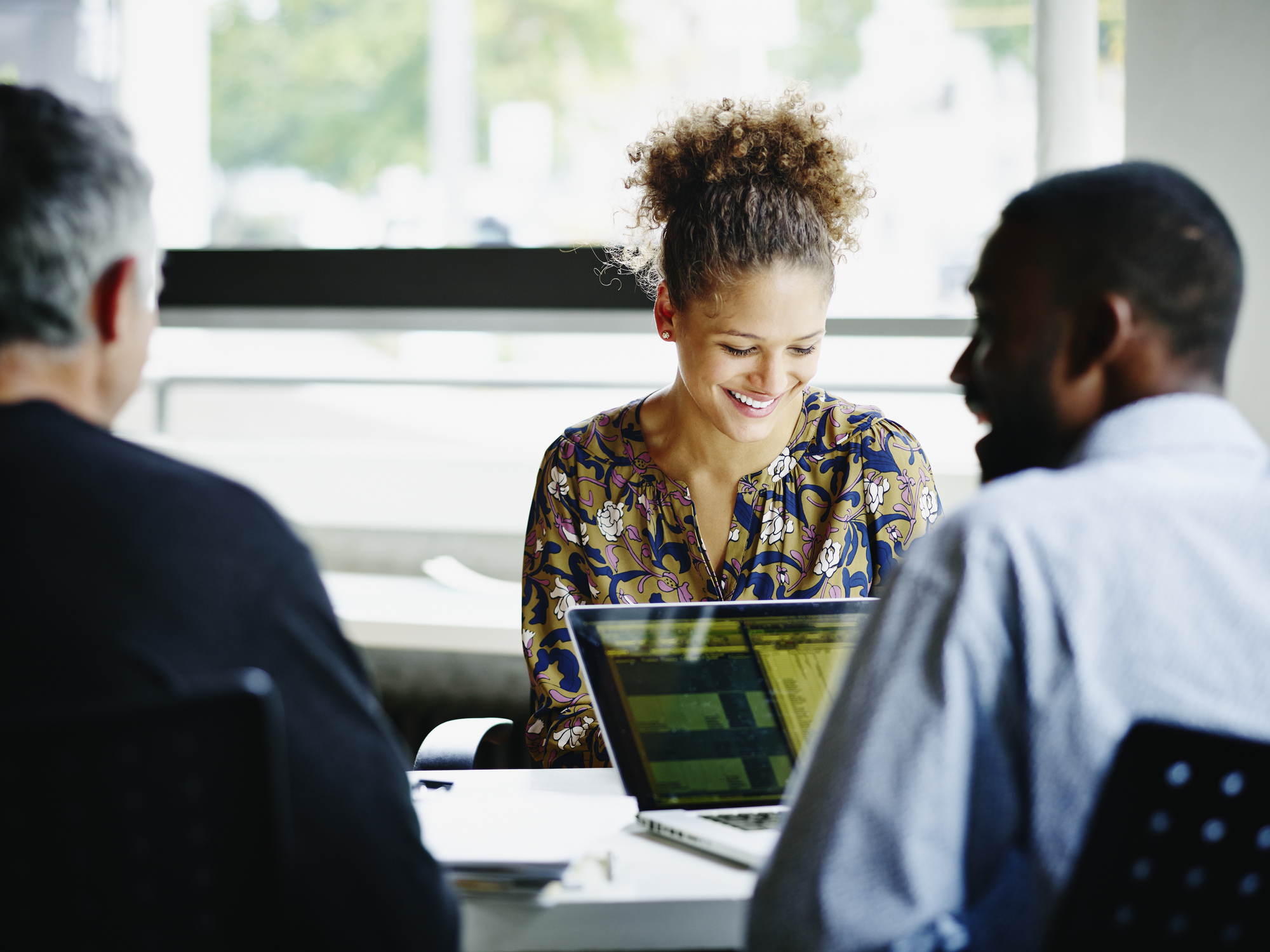 Group of people in meeting with computers